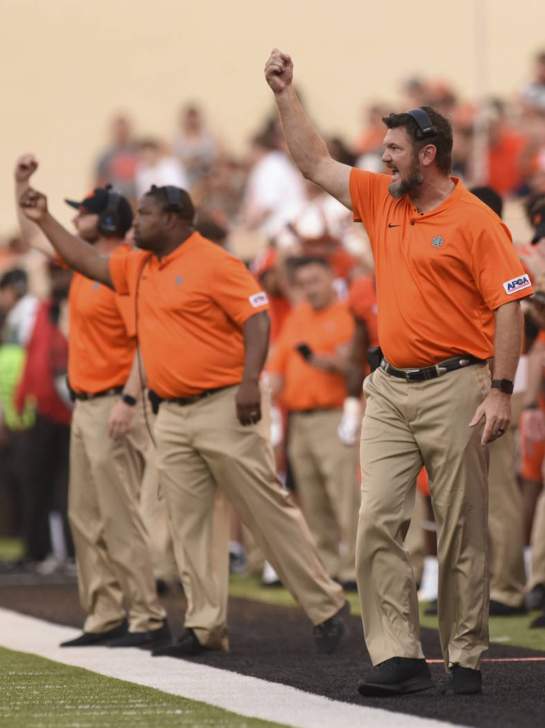 Oklahoma State defensive line coach Joe Bob Clements yells to his team during a college footbal ...