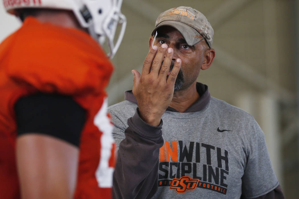 Oklahoma State's Kasey Dunn, associate head coach/receivers coach, talks to a player during an ...