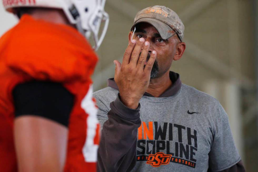 Oklahoma State's Kasey Dunn, associate head coach/receivers coach, talks to a player during an ...