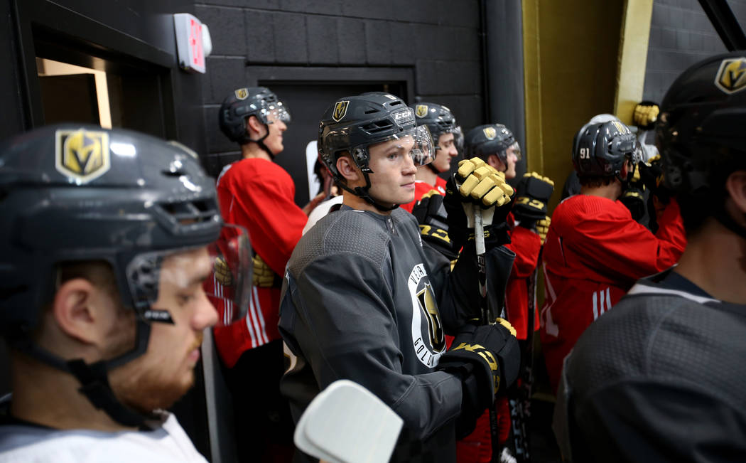 Vegas Golden Knights players, including defender Kaedan Korczak, center, prepare to take the ic ...