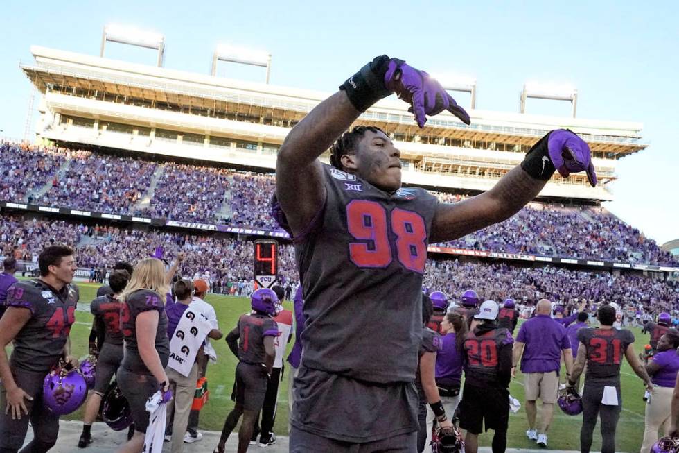 TCU defensive end Adam Plant Jr. (98) celebrates in the bench area during the final seconds of ...