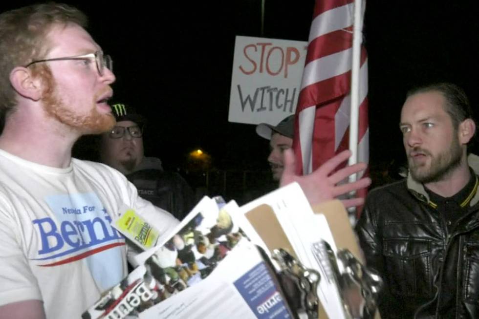 A staffer of Democratic presidential candidate Sen. Bernie Sanders, left, talks with protesters ...