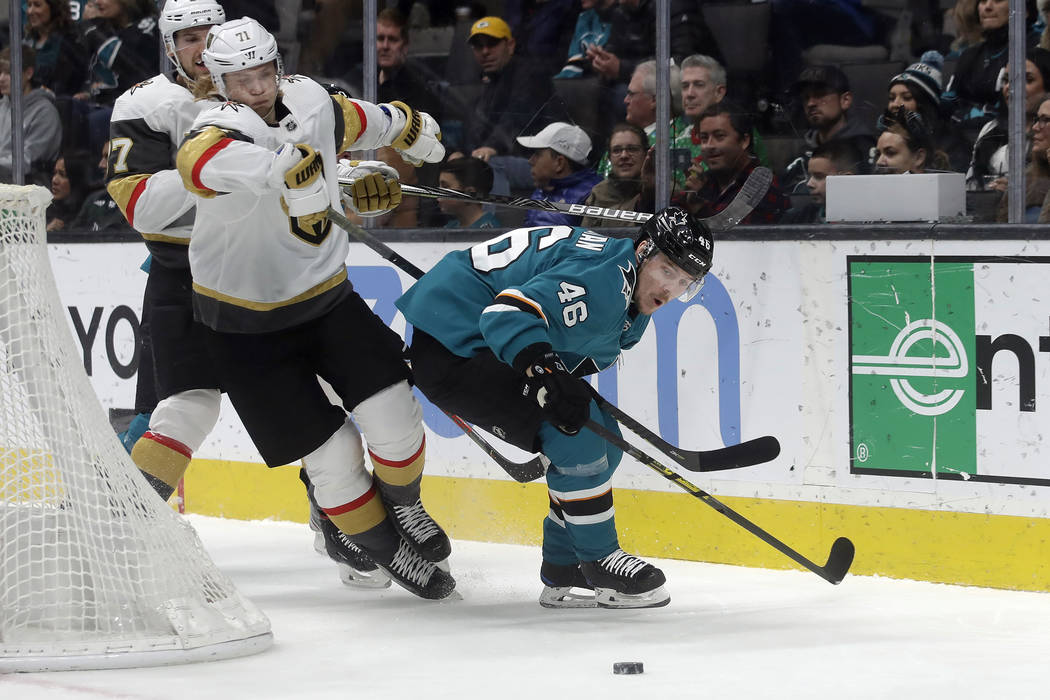 Vegas Golden Knights center William Karlsson, foreground left, goes after the puck next to San ...
