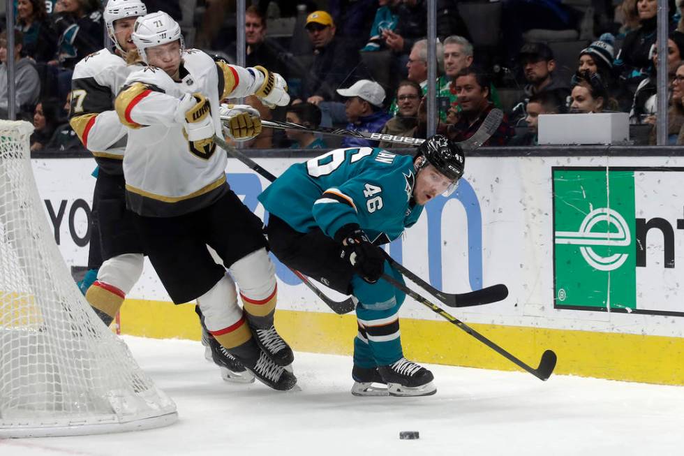 Vegas Golden Knights center William Karlsson, foreground left, goes after the puck next to San ...