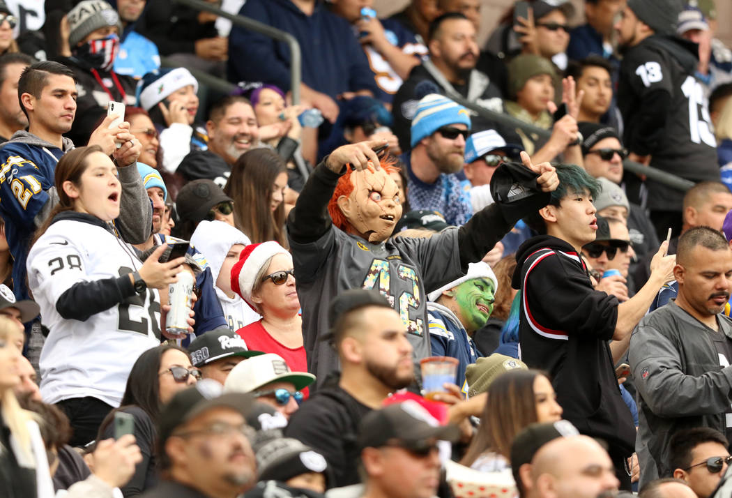 An Oakland Raiders fan in a Chucky mask cheers during the first half of an NFL game against the ...
