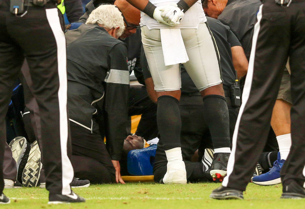 Oakland Raiders trainers examine Oakland Raiders cornerback Trayvon Mullen (27) as he is strapp ...