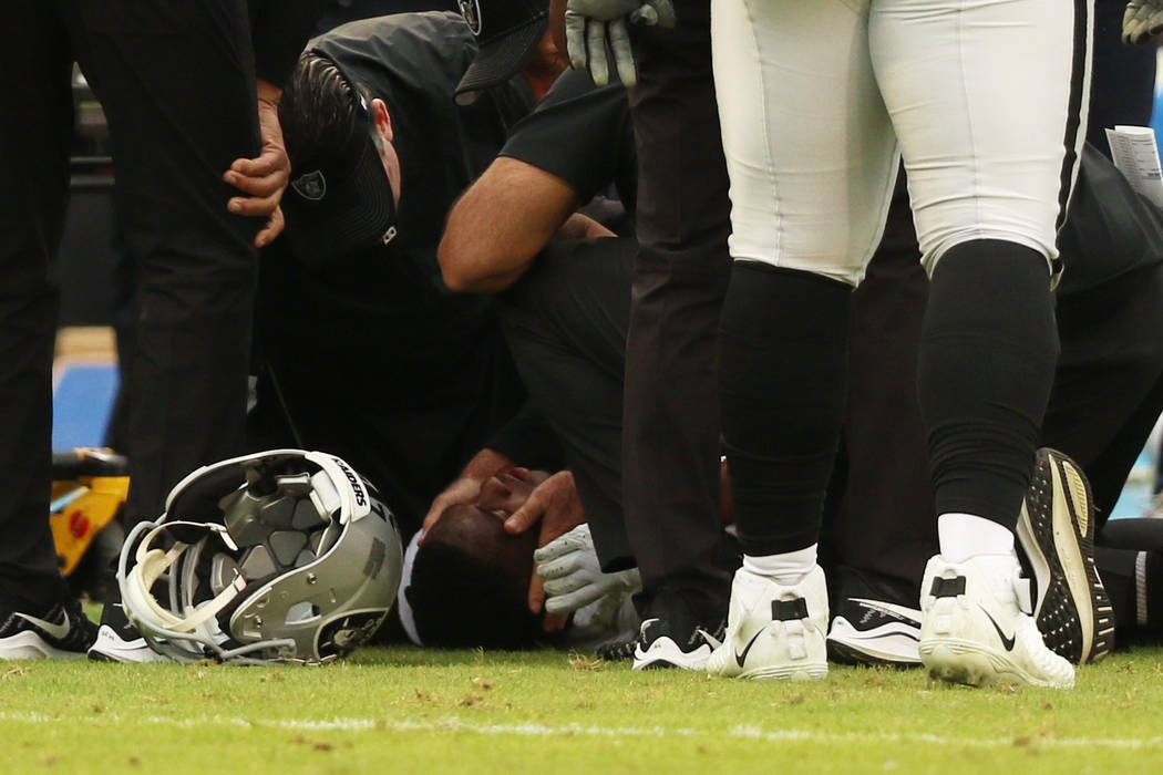 Oakland Raiders cornerback Trayvon Mullen is looked at by trainers after being injured during t ...