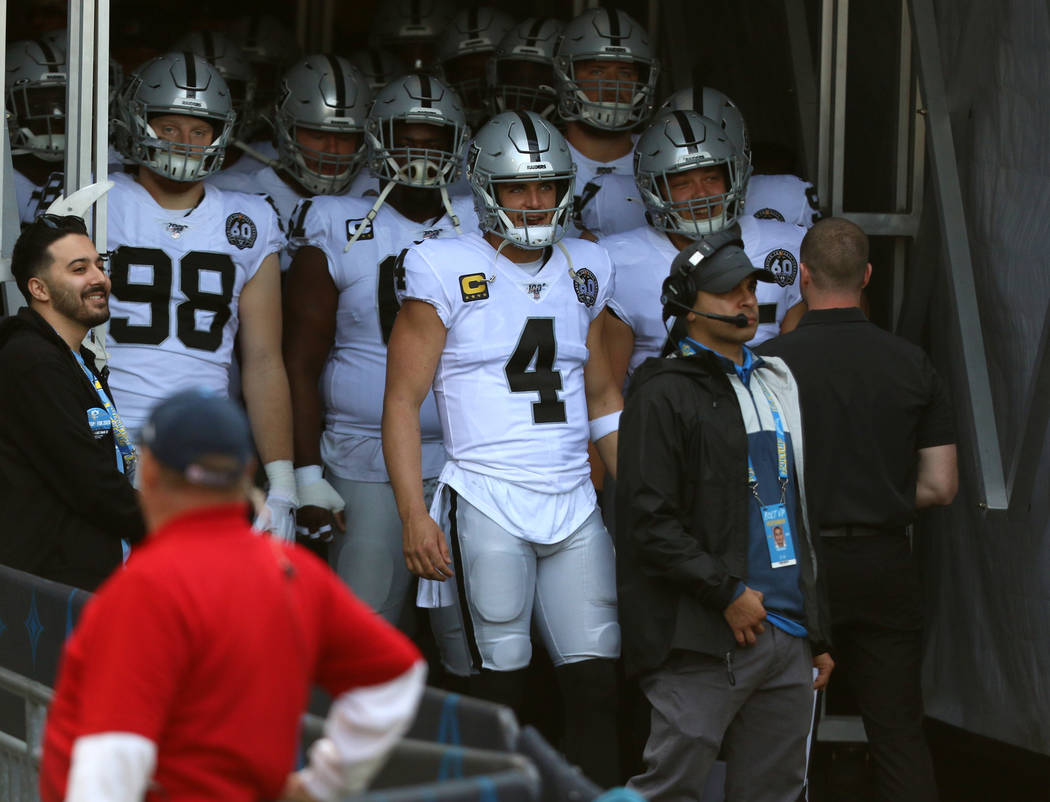 Oakland Raiders quarterback Derek Carr (4) prepares to lead the team out on the field as he is ...