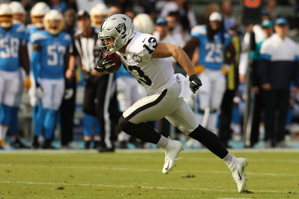 Oakland Raiders wide receiver Hunter Renfrow (13) breaks free from defenders and heads for the ...