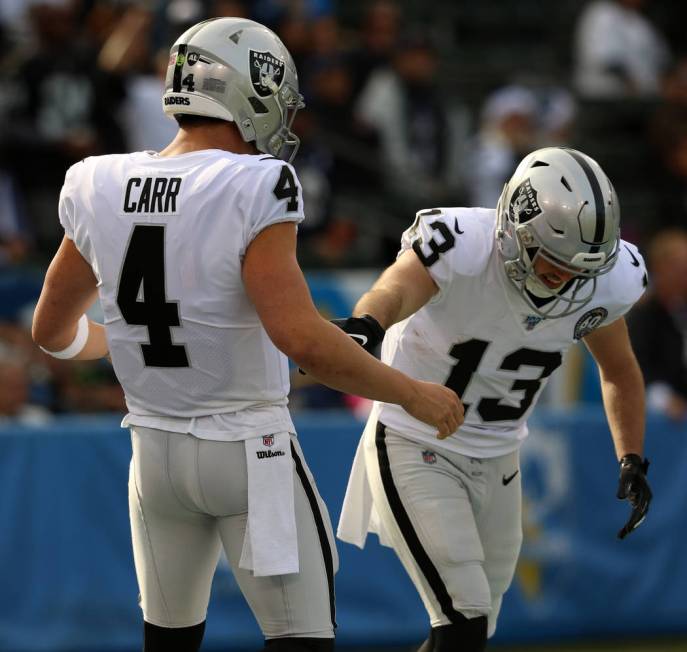 Oakland Raiders quarterback Derek Carr (4) comes to celebrate his touchdown pass with wide rece ...