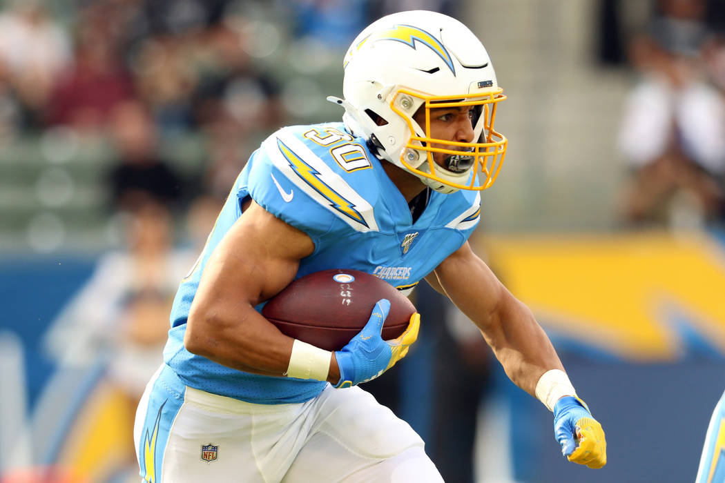 Los Angeles Chargers running back Austin Ekeler (30) runs with the football during the first ha ...