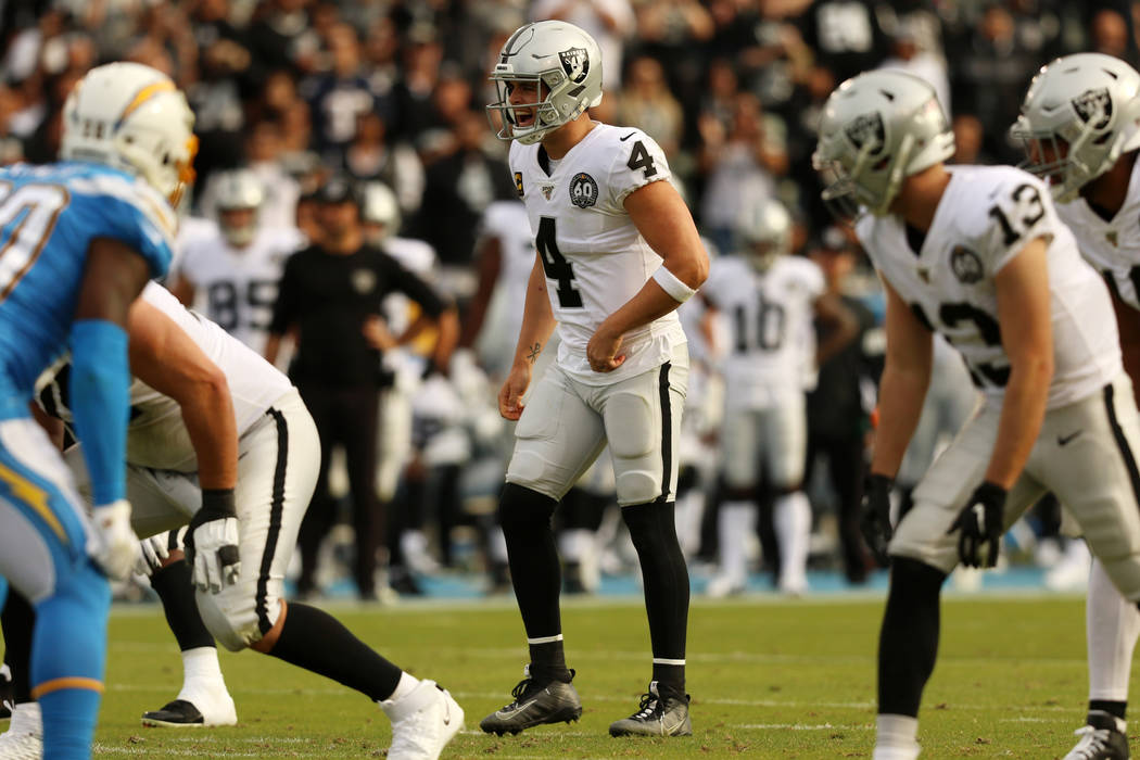 Oakland Raiders quarterback Derek Carr (4) calls an audible at the line of scrimmage during the ...