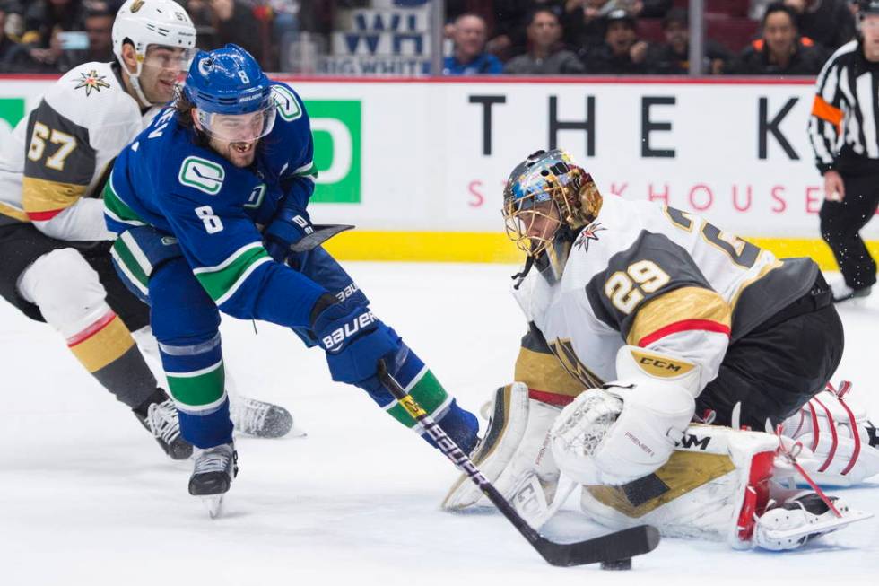 Vancouver Canucks defenseman Christopher Tanev (8) sends the game-winning goal past Vegas Golde ...