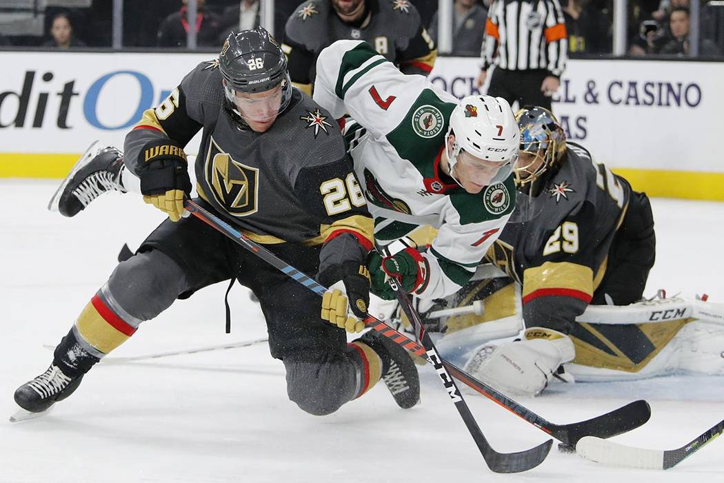 Vegas Golden Knights center Paul Stastny (26) and Minnesota Wild center Nico Sturm (7) vie for ...