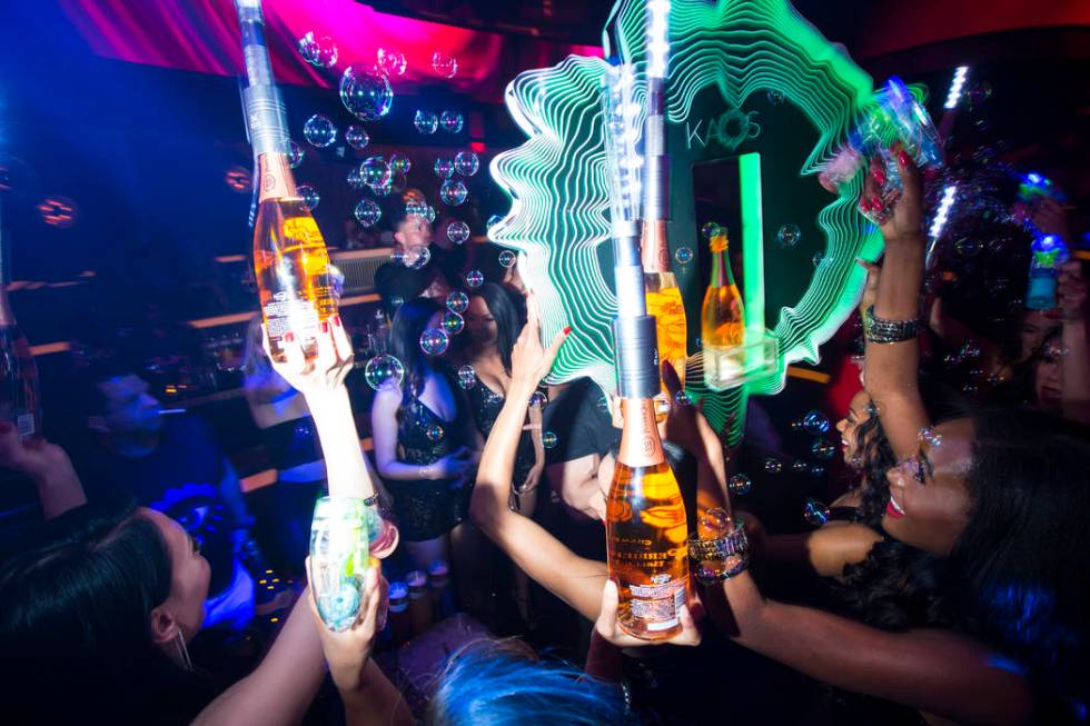 Bottles of champagne are delivered to a table in the nightclub area during the grand opening we ...