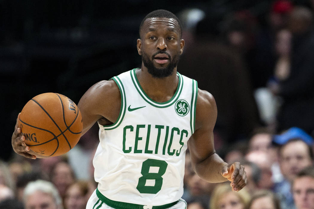 Boston Celtics guard Kemba Walker (8) dribbles the ball during the first half of an NBA basketb ...