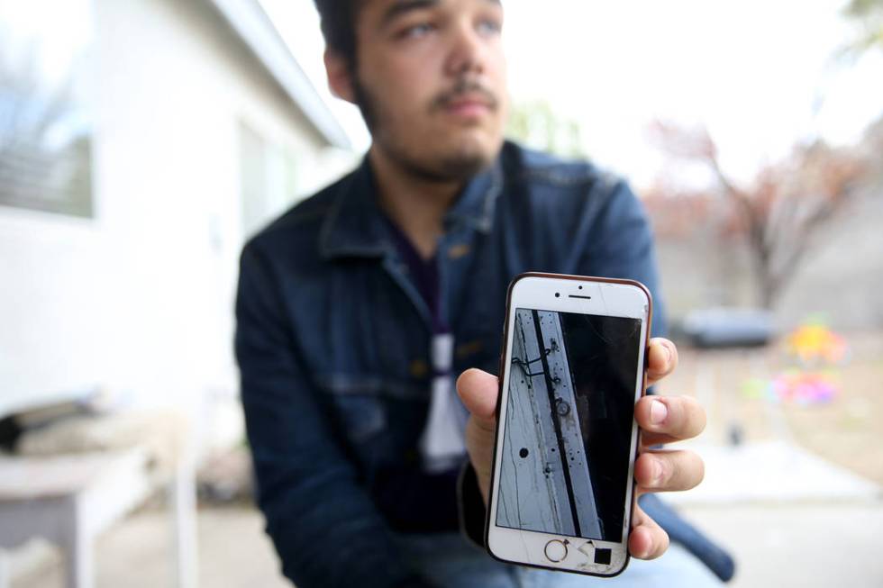 Jeremy Gordon, 18, on Tuesday, Dec. 24, 2019, shows a photo of the Alpine Motel Apartment's rea ...