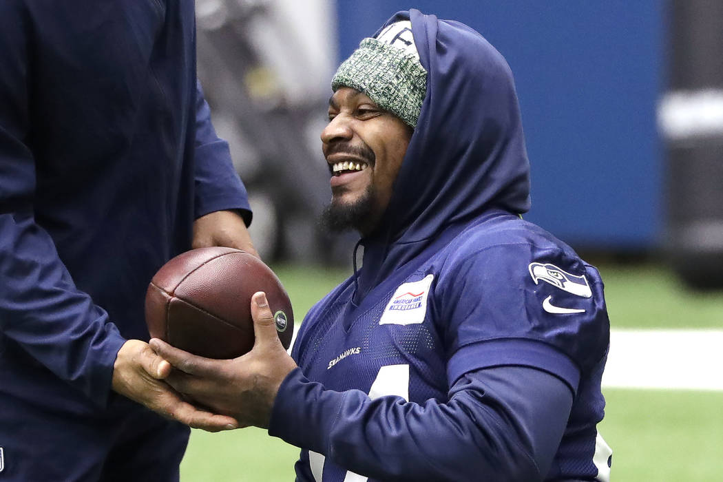 Seattle Seahawks running back Marshawn Lynch smiles during warmups at the NFL football team's p ...