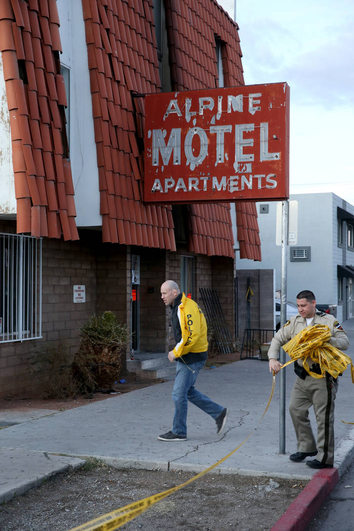 Las Vegas police remove crime scene tape at the Alpine Motel Apartments Wednesday, Dec. 25, 201 ...
