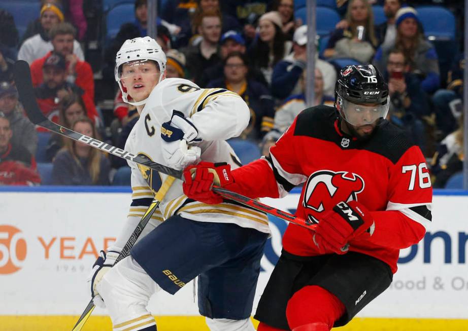 Buffalo Sabres forward Jack Eichel (9) and New Jersey Devils defenseman P.K. Subbam (76) collid ...