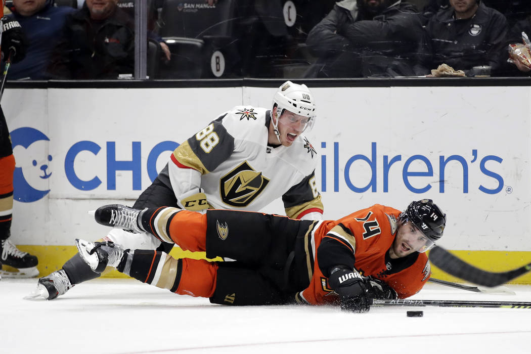 Vegas Golden Knights' Nate Schmidt (88) collides with Anaheim Ducks' Adam Henrique (14) during ...