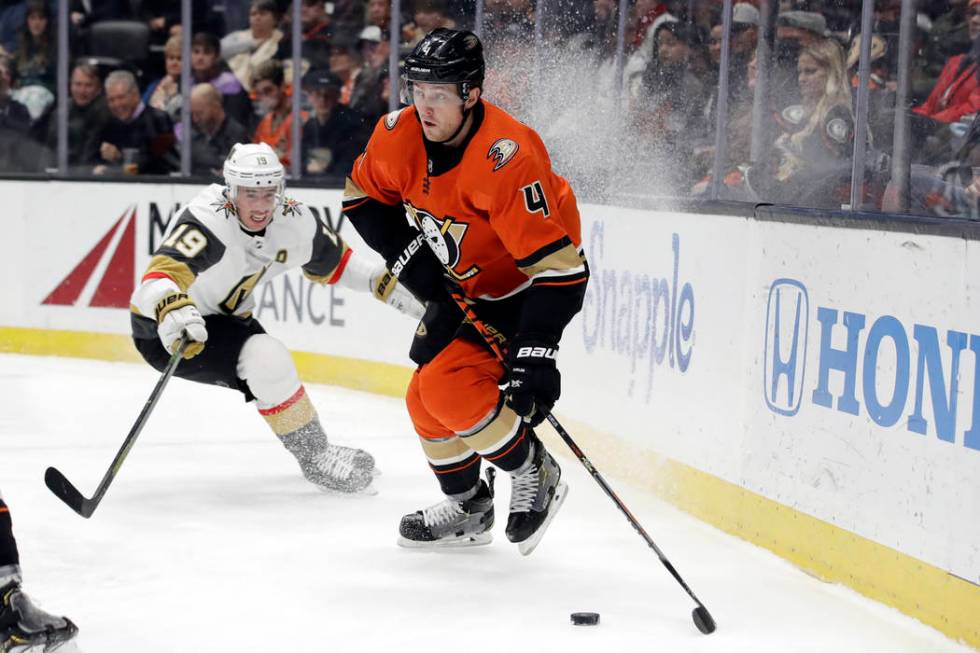 Anaheim Ducks' Cam Fowler (4) controls the puck in front of Vegas Golden Knights' Reilly Smith ...