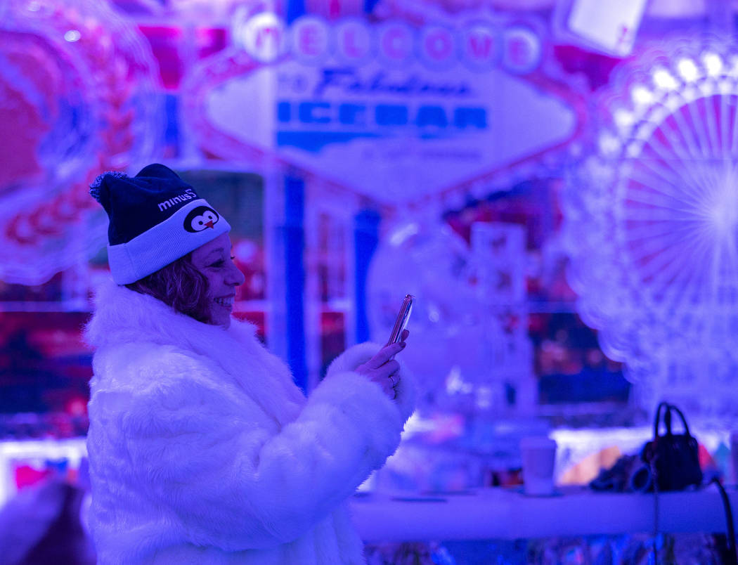 Ginny Lane of Connecticut takes a photo of her daughter at ICEBAR Las Vegas in The Linq Promena ...