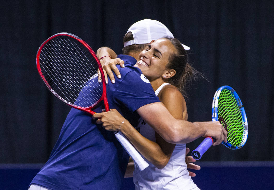 The Vegas Rollers' Bob Bryan, left, embraces mixed doubles parter Monica Puig, 2016 Rio Olympic ...
