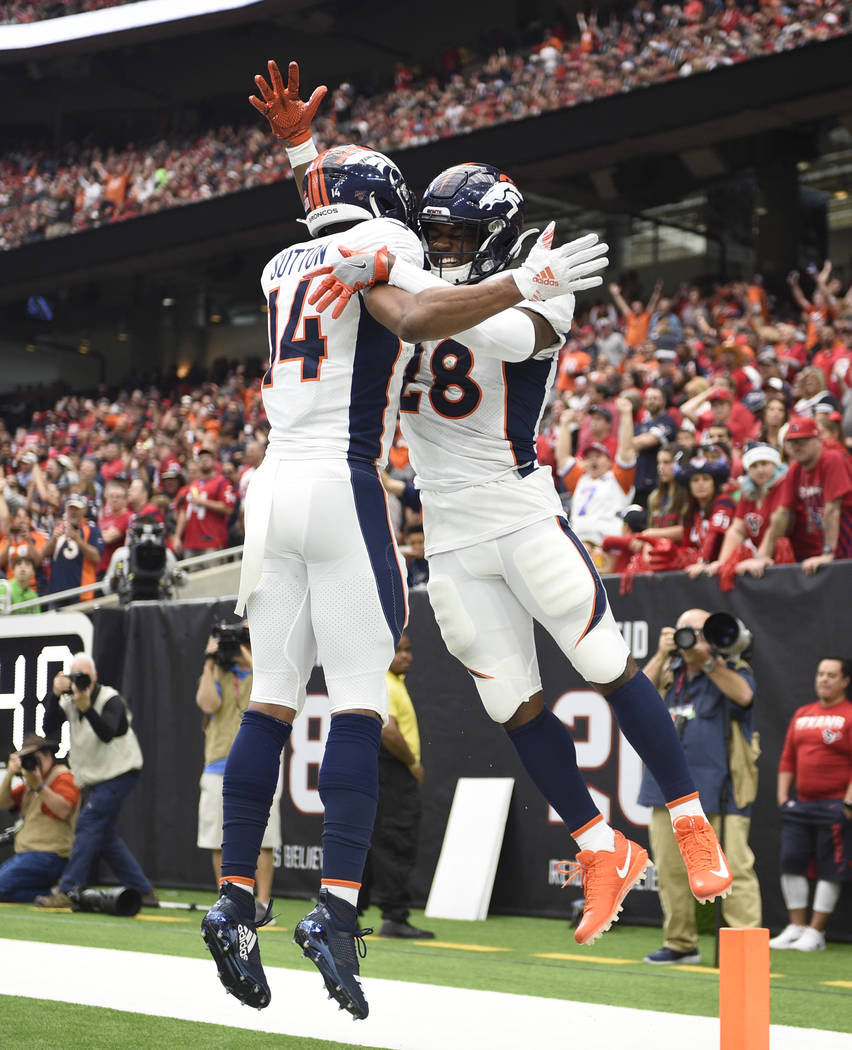 Denver Broncos running back Royce Freeman (28) celebrates his touchdown catch with teammate Cou ...