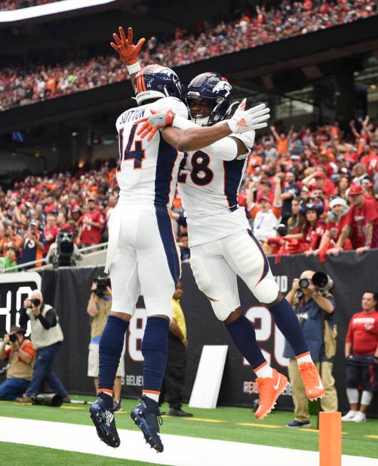 Denver Broncos running back Royce Freeman (28) celebrates his touchdown catch with teammate Cou ...