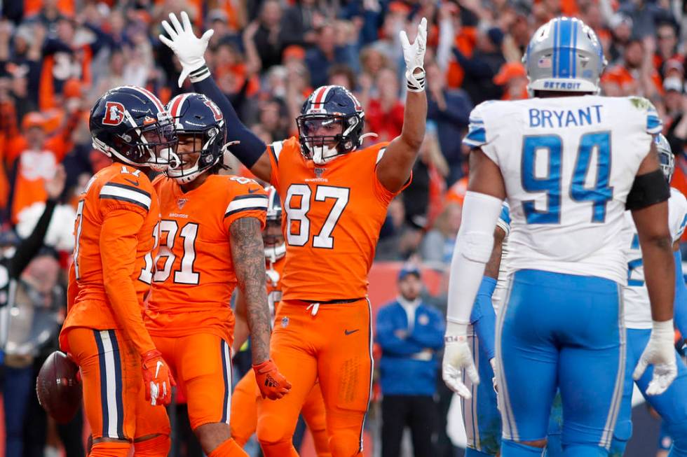 Denver Broncos wide receiver DaeSean Hamilton, left, celebrates his touchdown against the Detro ...