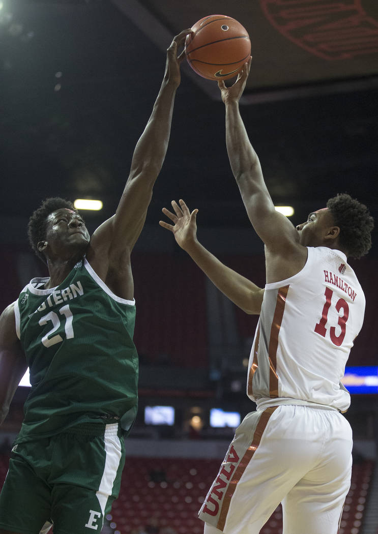 UNLV Rebels guard Bryce Hamilton (13) reaches out to block the shot of Eastern Michigan Eagles ...