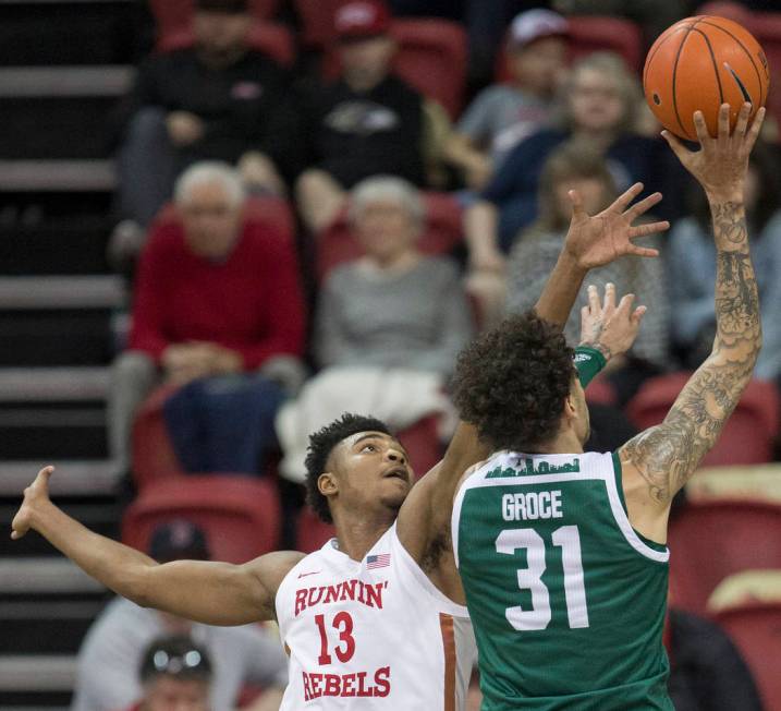 UNLV Rebels guard Bryce Hamilton (13) reaches out to block the shot of Eastern Michigan Eagles ...