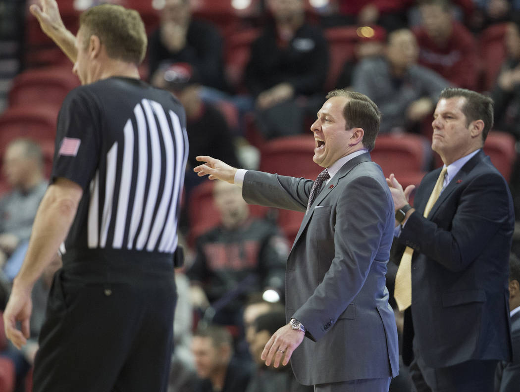 UNLV Rebels head coach T.J. Otzelberger, middle, calls out a play in the first half during an N ...