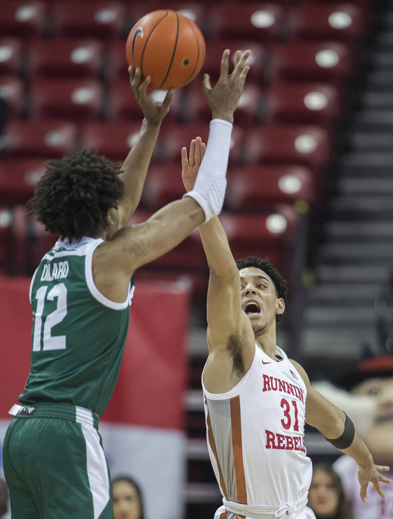 UNLV Rebels guard Marvin Coleman (31) extends to block the shot of Eastern Michigan Eagles guar ...