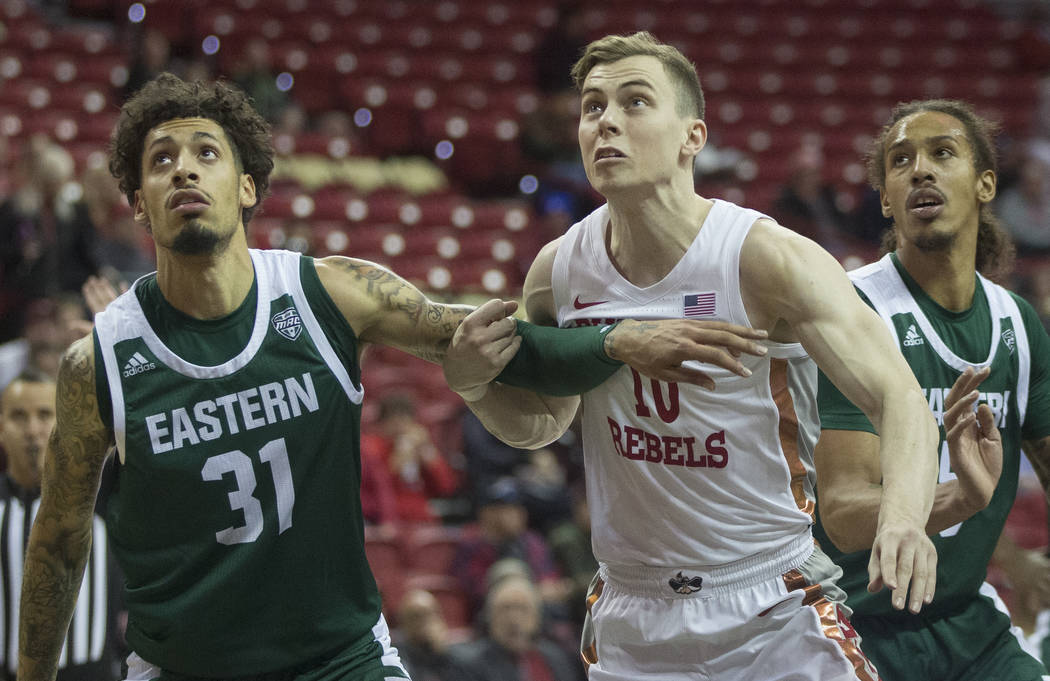 UNLV Rebels guard Jonah Antonio (10) fight for position with Eastern Michigan Eagles forward Ty ...