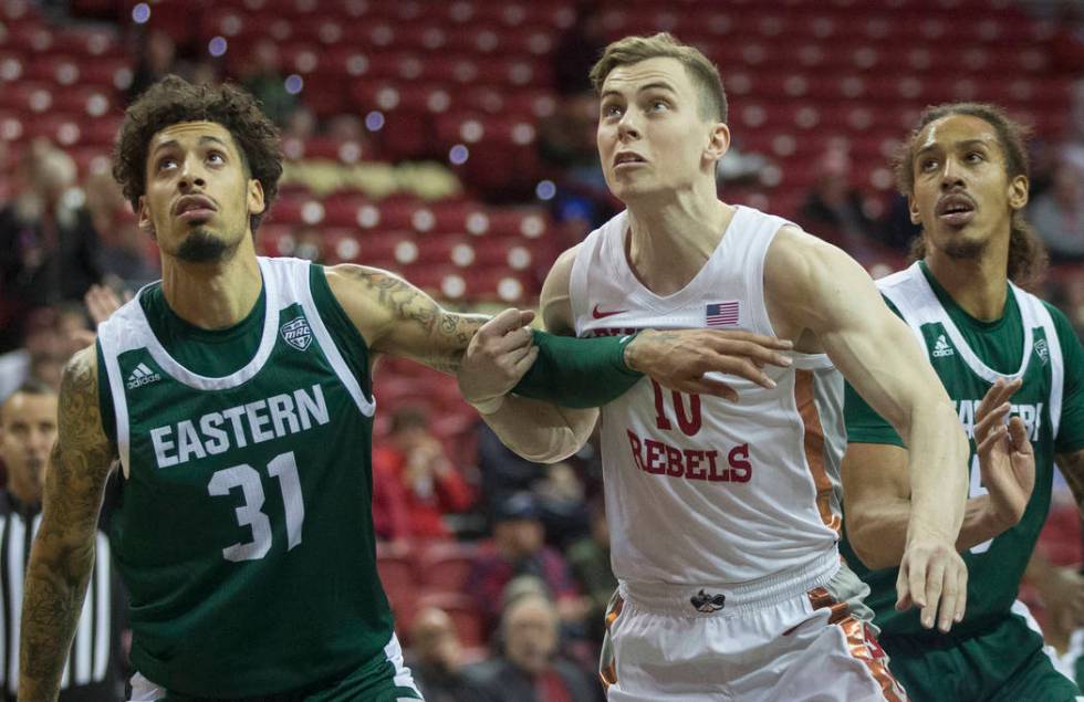 UNLV Rebels guard Jonah Antonio (10) fight for position with Eastern Michigan Eagles forward Ty ...