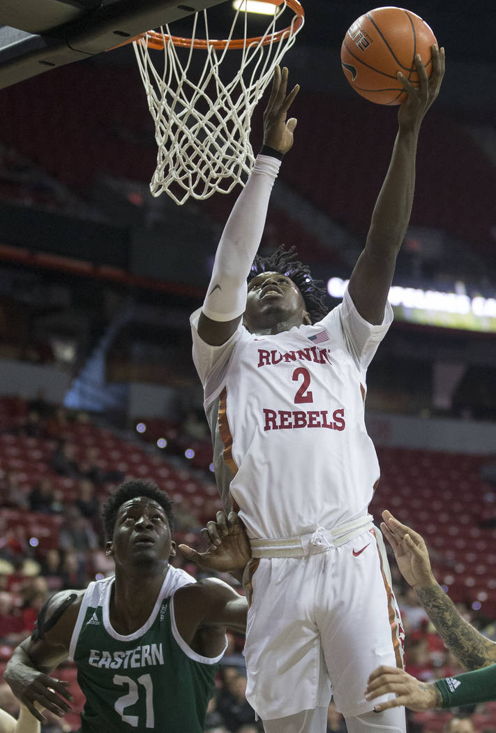 UNLV Rebels forward Donnie Tillman (2) slices to the rim past Eastern Michigan Eagles center Bo ...