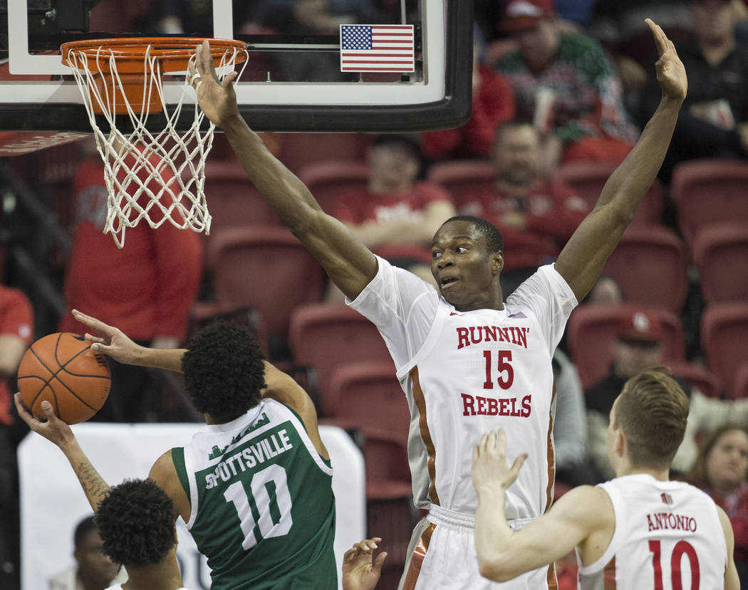 UNLV Rebels forward Cheickna Dembele (15) extends to block the shot of Eastern Michigan Eagles ...