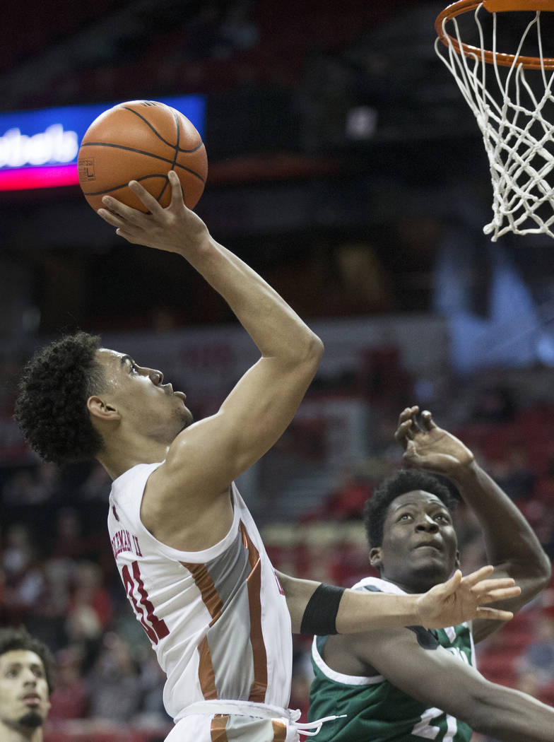 UNLV Rebels guard Bryce Hamilton (13) slices to the rim past Eastern Michigan Eagles center Bou ...