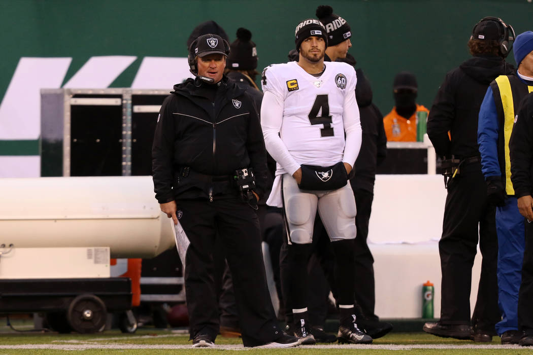 Oakland Raiders head coach Jon Gruden and quarterback Derek Carr (4) stand on the sideline afte ...