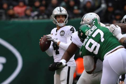 Oakland Raiders quarterback Derek Carr (4) looks for an open receiver to throw to as New York J ...