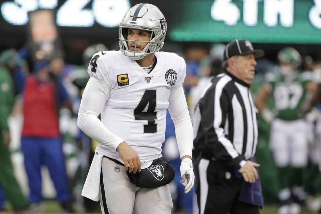 Oakland Raiders quarterback Derek Carr reacts during the second half of an NFL football game ag ...