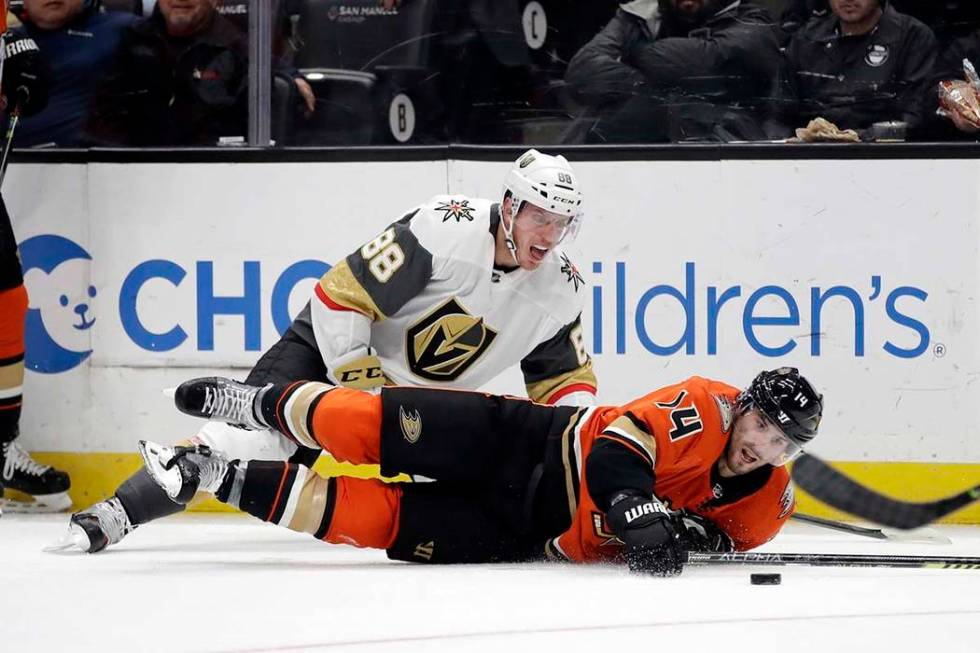 Vegas Golden Knights' Nate Schmidt (88) collides with Anaheim Ducks' Adam Henrique (14) during ...