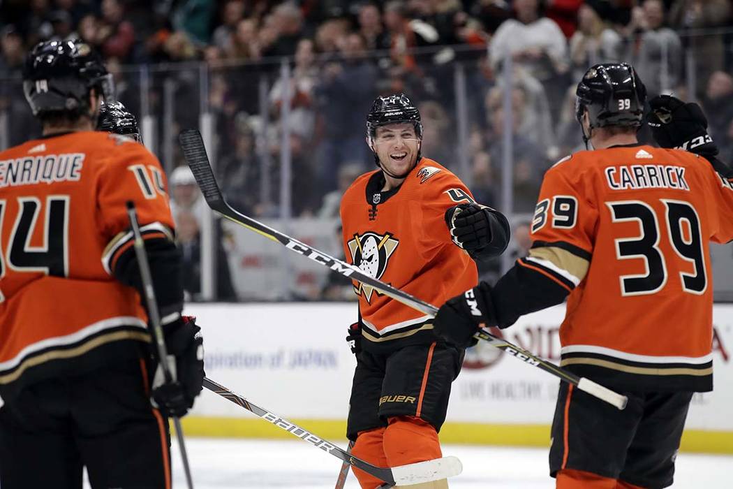 Anaheim Ducks' Cam Fowler, center, celebrates his goal with Adam Henrique, left, and Sam Carric ...