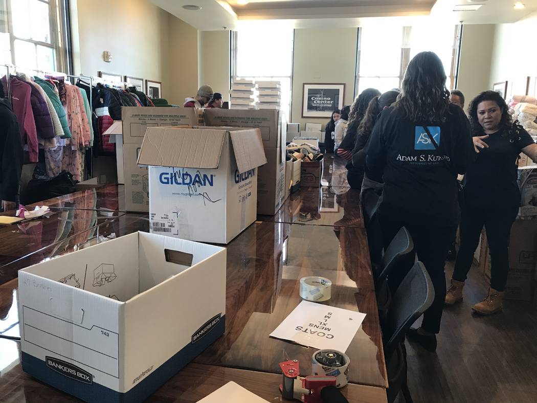 Volunteers work Saturday at the Mob Museum to sort donated items brought in through a Downtown ...