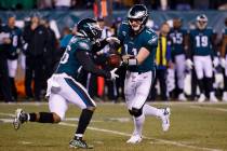 Philadelphia Eagles quarterback Carson Wentz (11) hands the ball off to running back Miles Sand ...