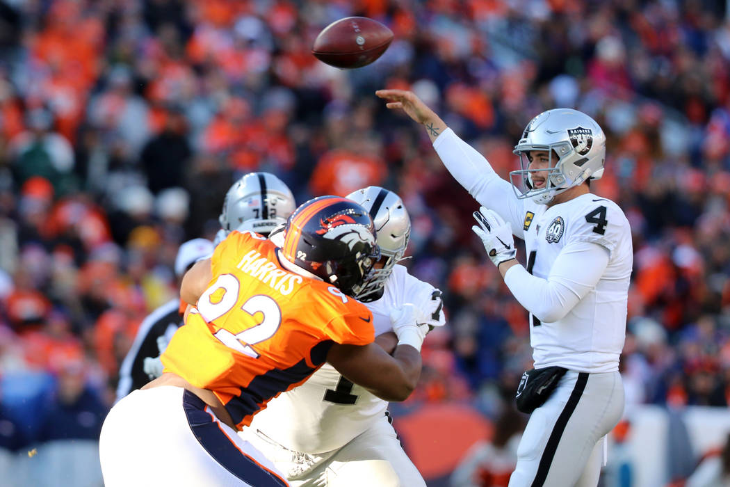 Oakland Raiders quarterback Derek Carr (4) throws the football as offensive tackle Denzelle Goo ...