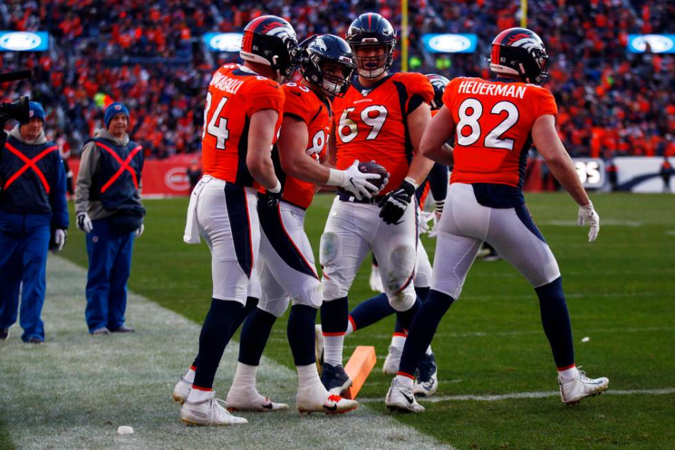 Denver Broncos fullback Andrew Beck (83) celebrates his touchdown score with tight end Troy Fum ...