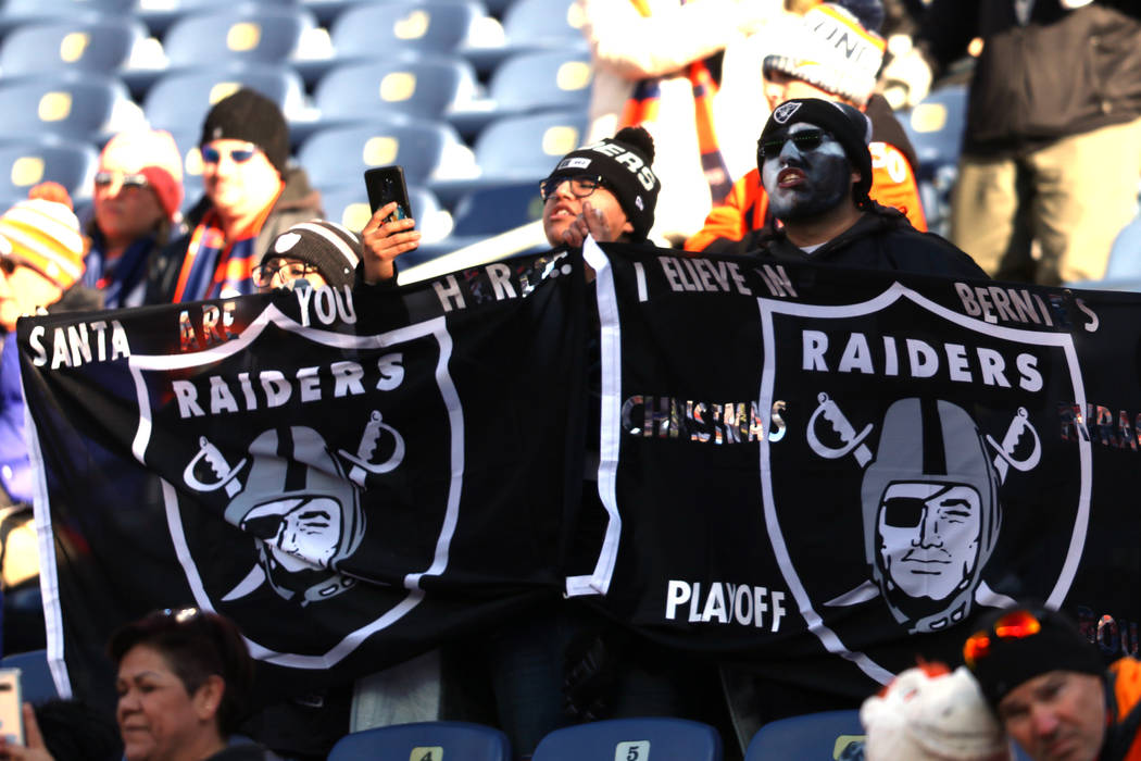 Oakland Raiders fans wave their flag prior to an NFL game against the Denver Broncos at Empower ...